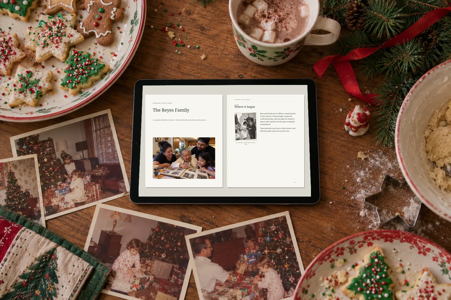 The sample family book open on a tablet among Christmas cookies and old family Christmas photos